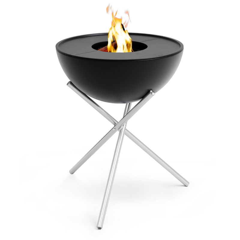 The Bowl 70 BBQ Set High is shown as a fire pit with with a fire burning in it, creating a stylish and accessible visual.
