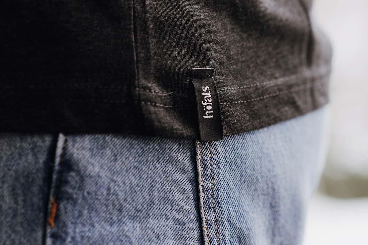 SHIRT Men grey M Depicted here is a man wearing a black shirt and jeans, with the SHIRT Men grey S.