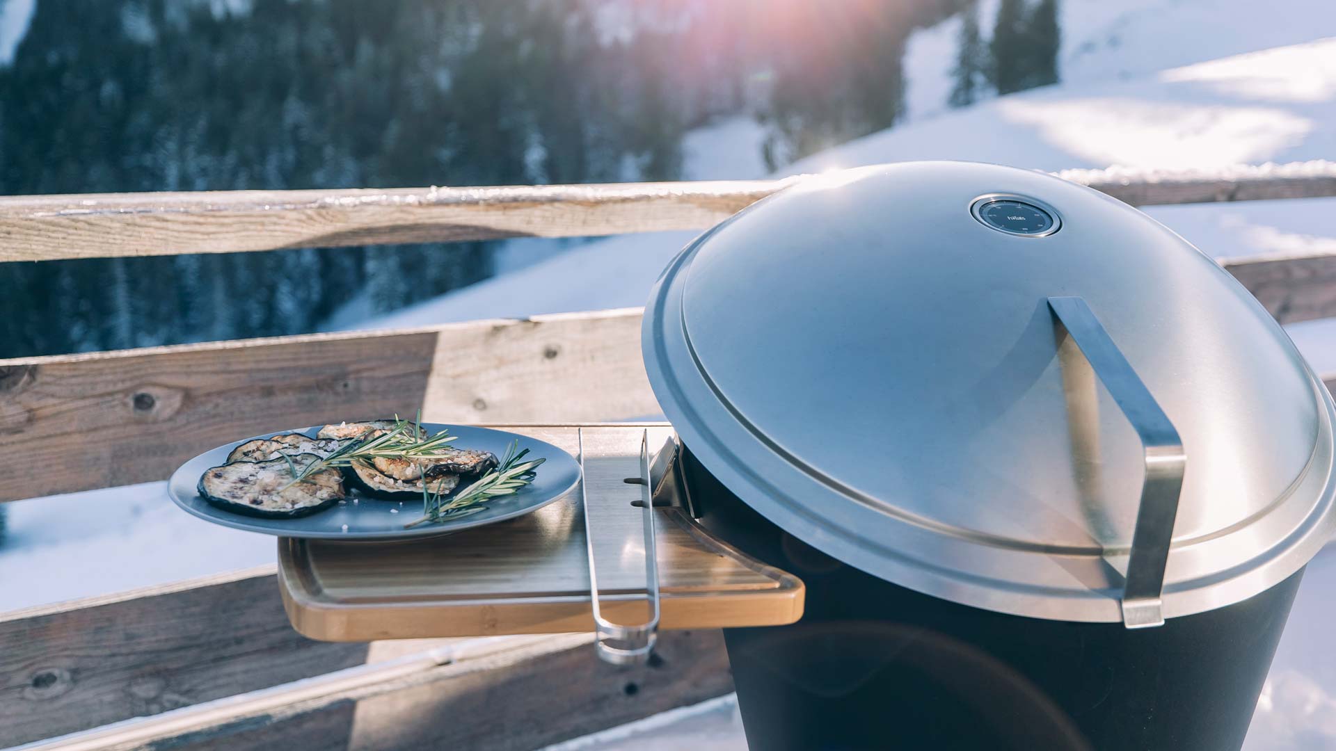 The photo presents a plate of food on a grill on a deck, with the CONE Board.