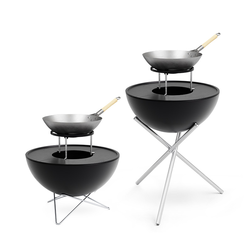 An inviting scene with a black barbecue set with a large pan and a small pan, highlighted by the presence of the 00611 Bowl 57 Sear Grate