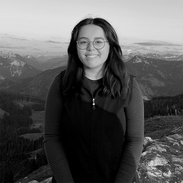 a woman standing on top of a mountain