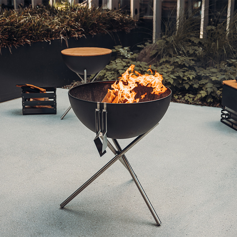 The Bowl 57 is shown as a fire pit, creating a stylish and accessible visual.