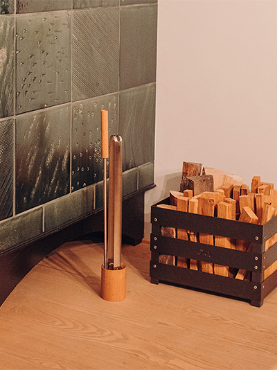 Depicted here is a bed with a wooden headboard, with the Fire Tools Set 3 pcs.