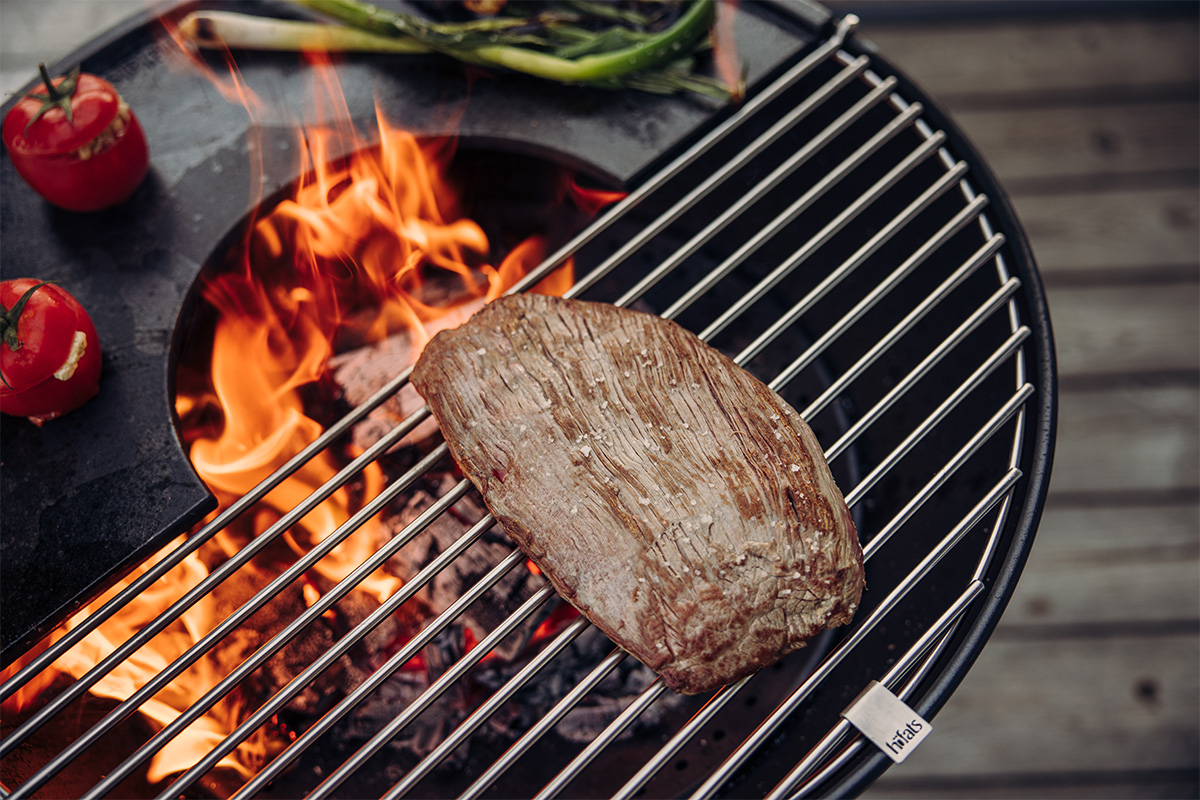 A view of a steak on a grill, with the BOWL 57 Grid.