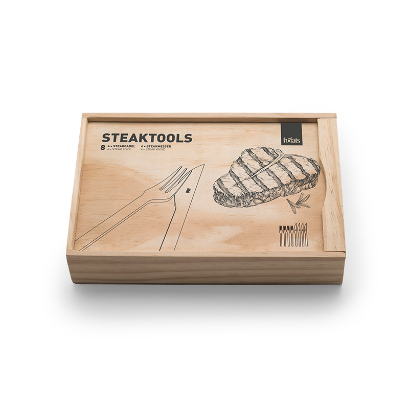 Steaktools A view of a wooden box with a drawing of a steak, with the TOOLS Steaktools.