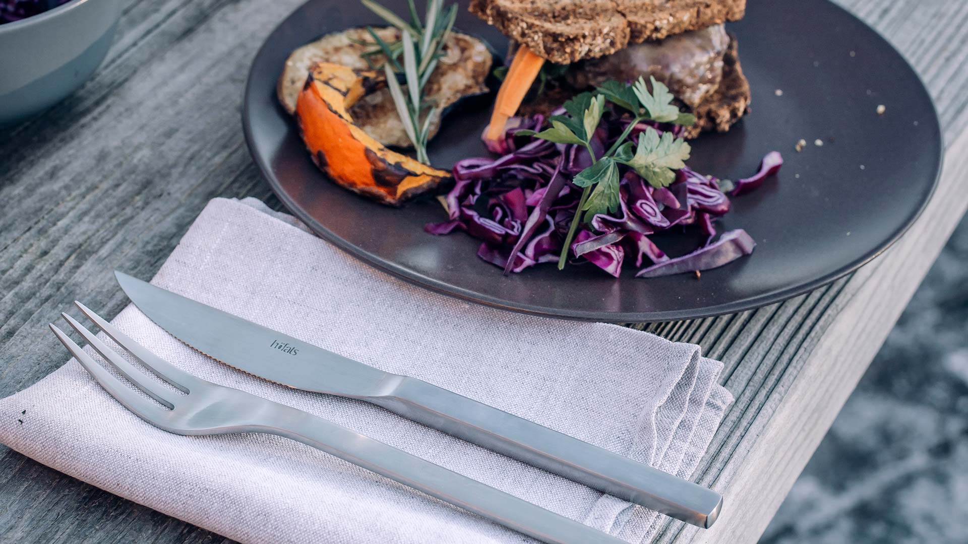 Illustrated is a plate with a knife and some food