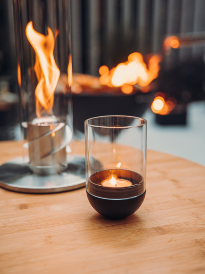 Experience a candle on a table with the refined touch of the 00544 Gravity Candle black