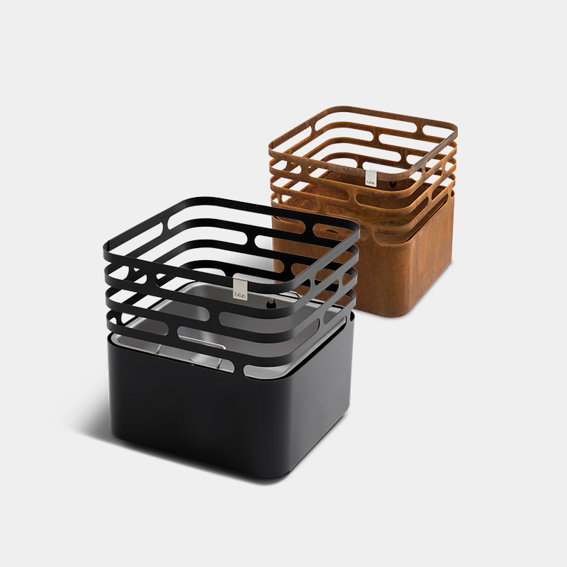 An image showing three wooden containers with metal handles, with the CUBE Plancha.