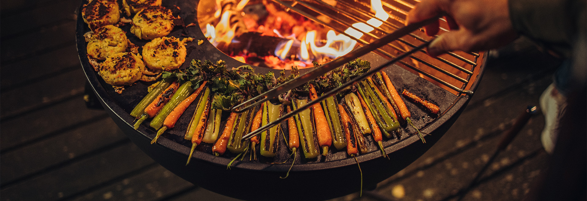 The Bowl 70 is shown as a person is cooking food on a grill, creating a stylish and accessible visual.