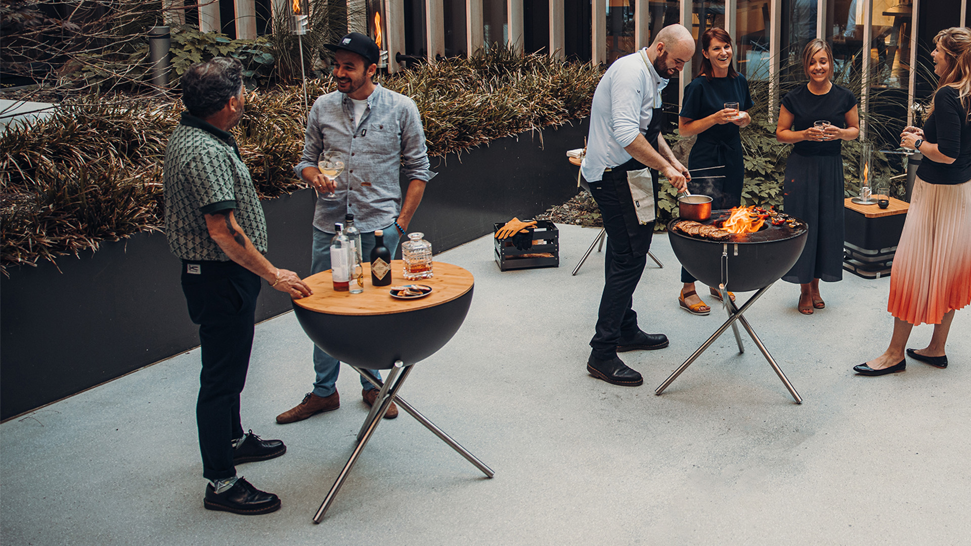 This image shows a group of people standing around a table, with the BOWL 70 Board.