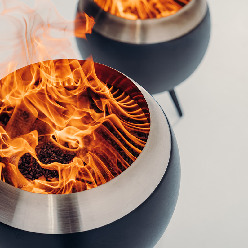 A depiction of two metal bowls with fire inside, featuring the Moon 45 as a central and purposeful element.