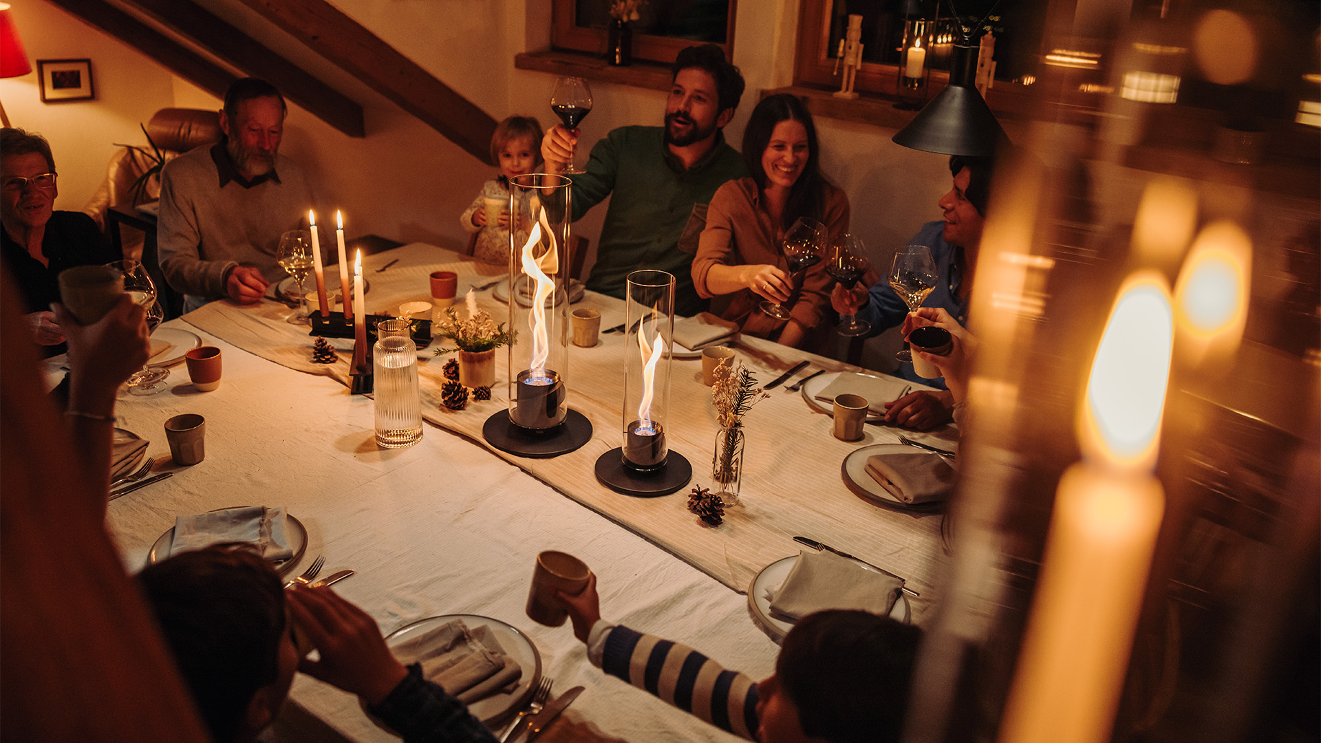 a group of people sitting around a table with the refined touch of the SPIN Tablefires.