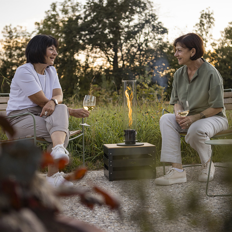Two women sitting on a bench the Spin 900 complements the moment with its thoughtful design.