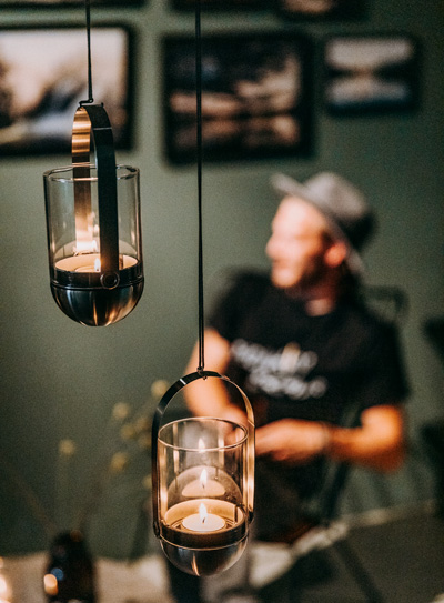 Illustrated is three hanging glass lanterns with candles inside, with the LOGO GRAVITY CANDLE M90 Lantern.