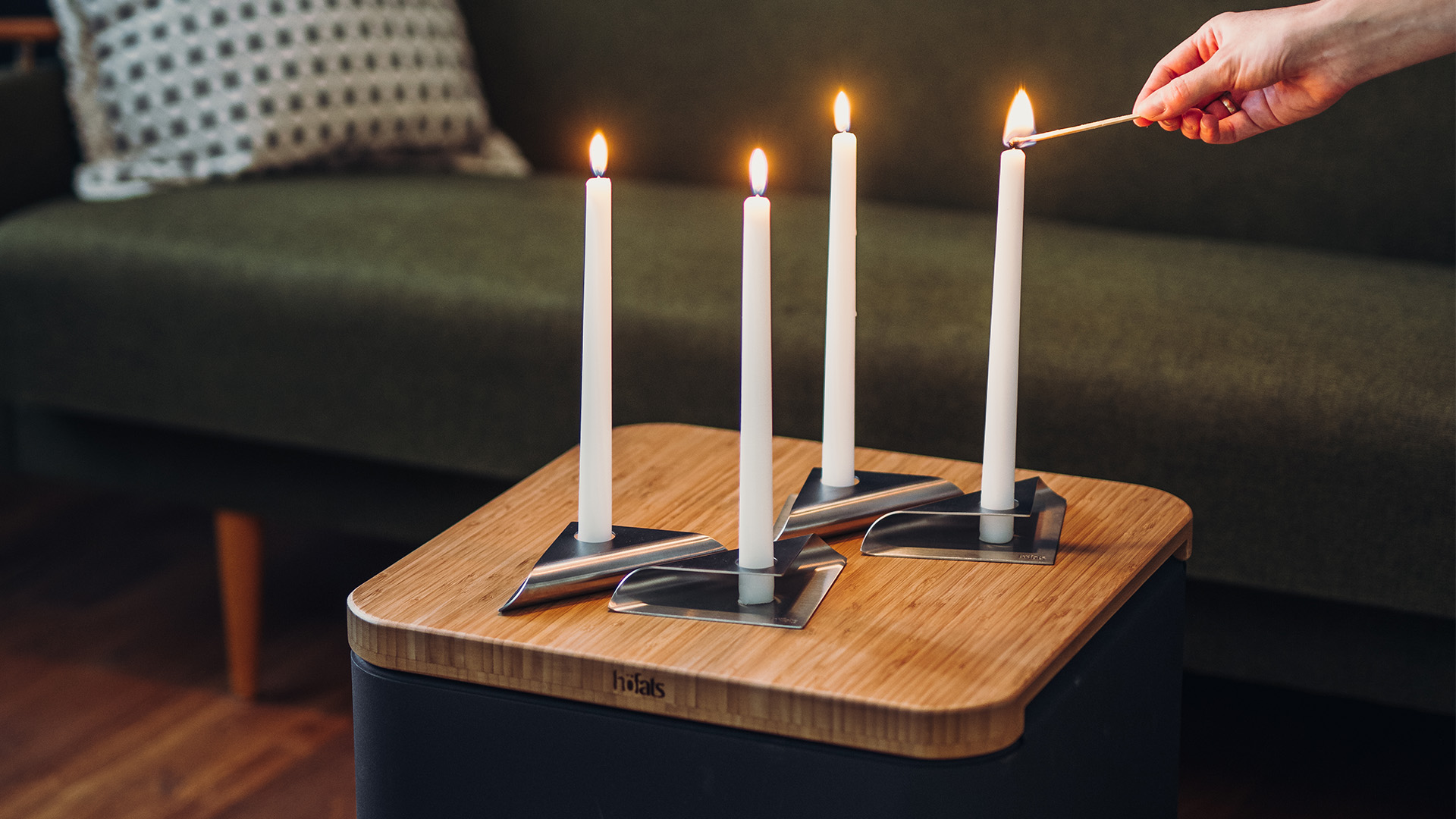 Depicted here is a person lighting a candle on a table, with the SQUARE CANDLE (Matrix - Parent).