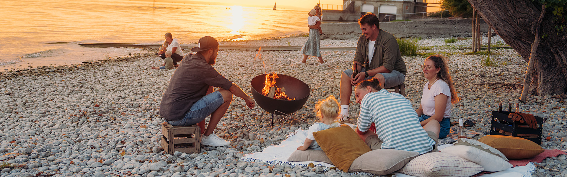 a group of people sitting on a beach
