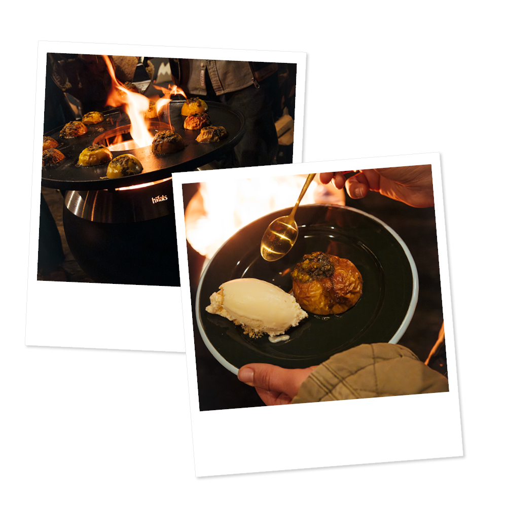 A person holding a plate of food with a fire in the background