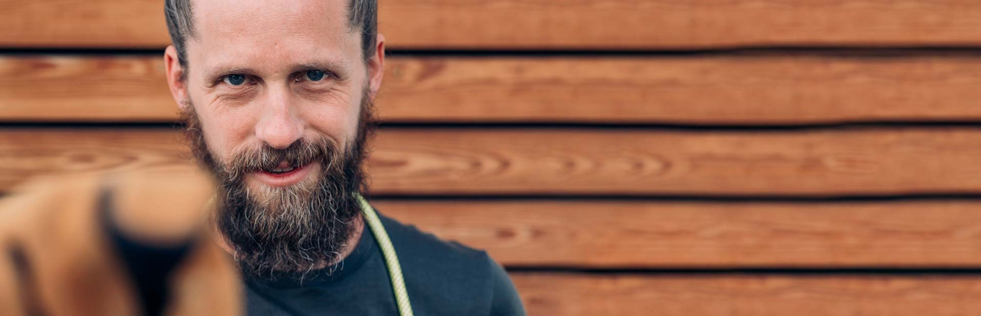 a man with a beard and a black shirt.