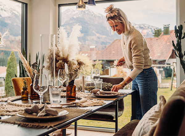 Christmas decorations a woman standing in front of a window with a decorated table showing the spin tablefire