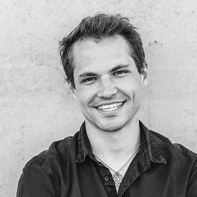 a man in a black shirt and jeans