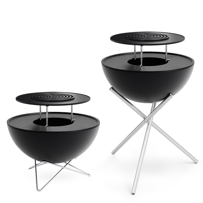 Illustrated is two black outdoor tables with a metal stand, with the BOWL 70 Warming Ring.