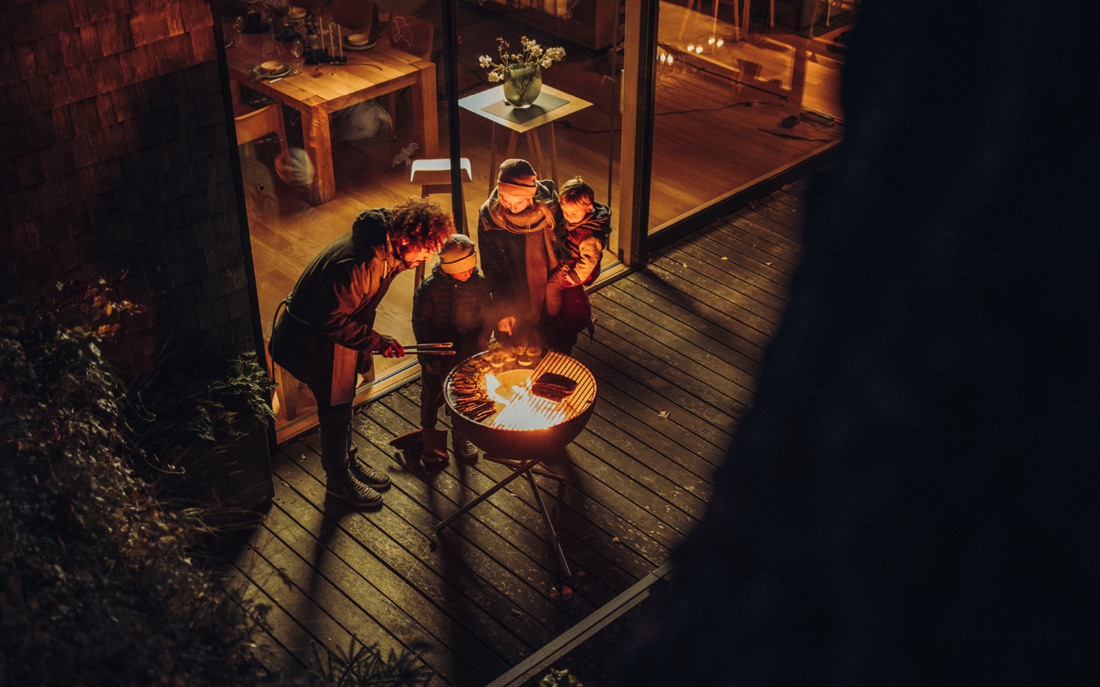 Experience a group of people standing around a fire pit