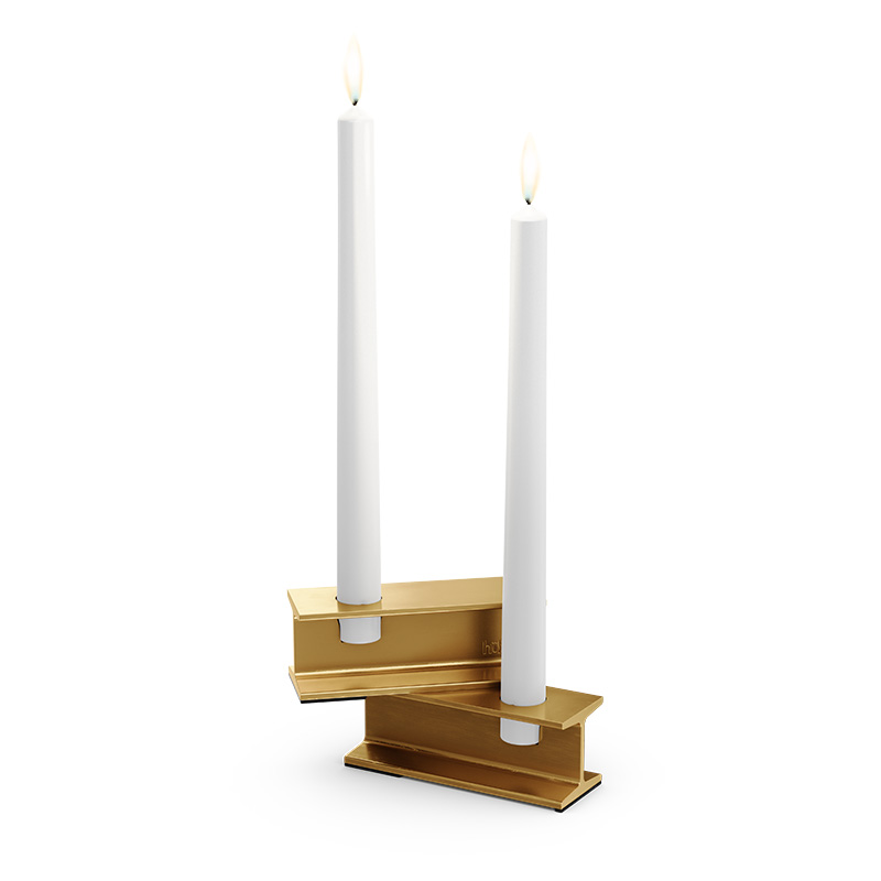 A view of a pair of candles on a stand, with the HENRY METAL I Candleholder gold.