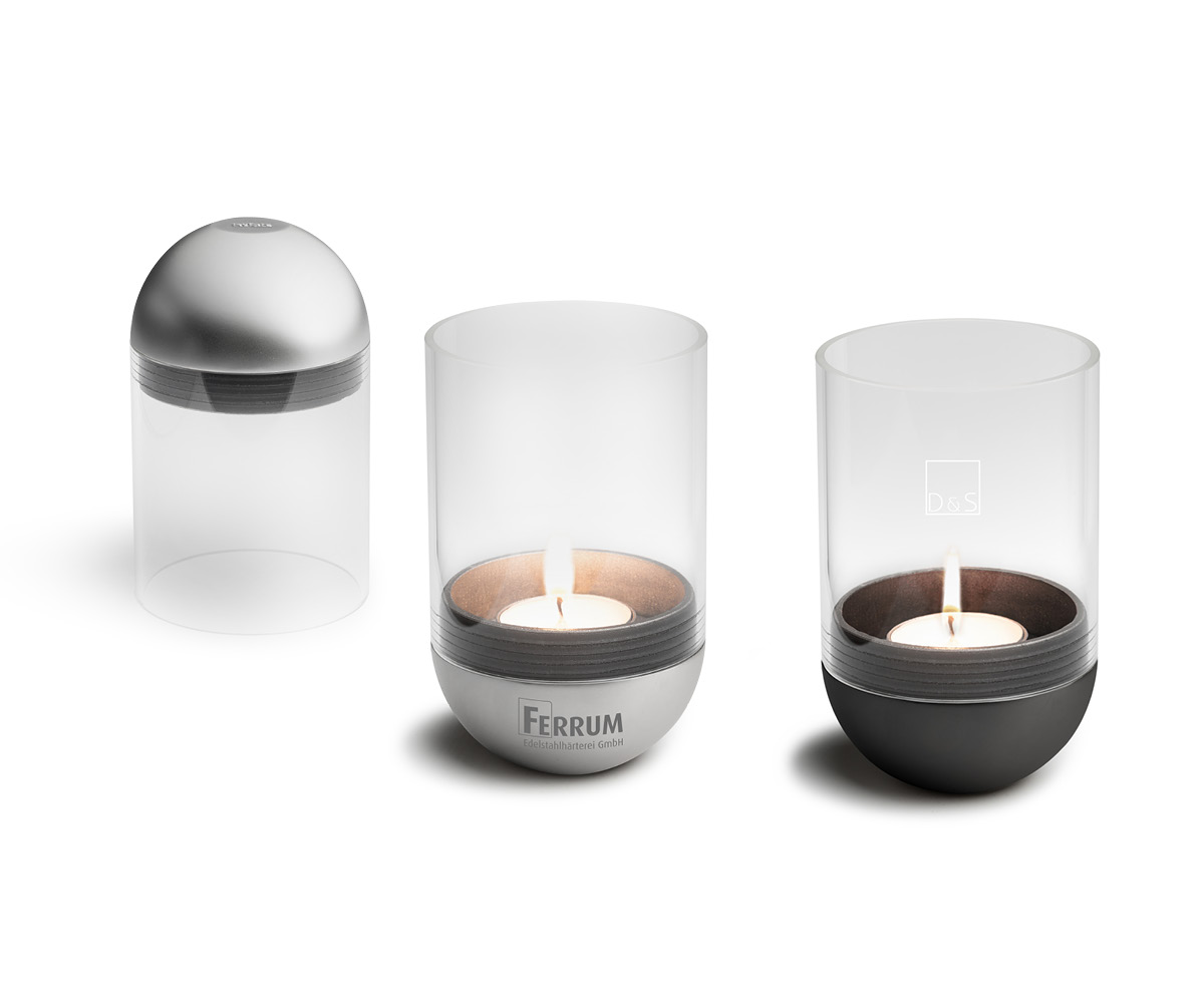 A view of the three candles are shown in different sizes and shapes, with the LOGO SPIN Table-top fireplace.