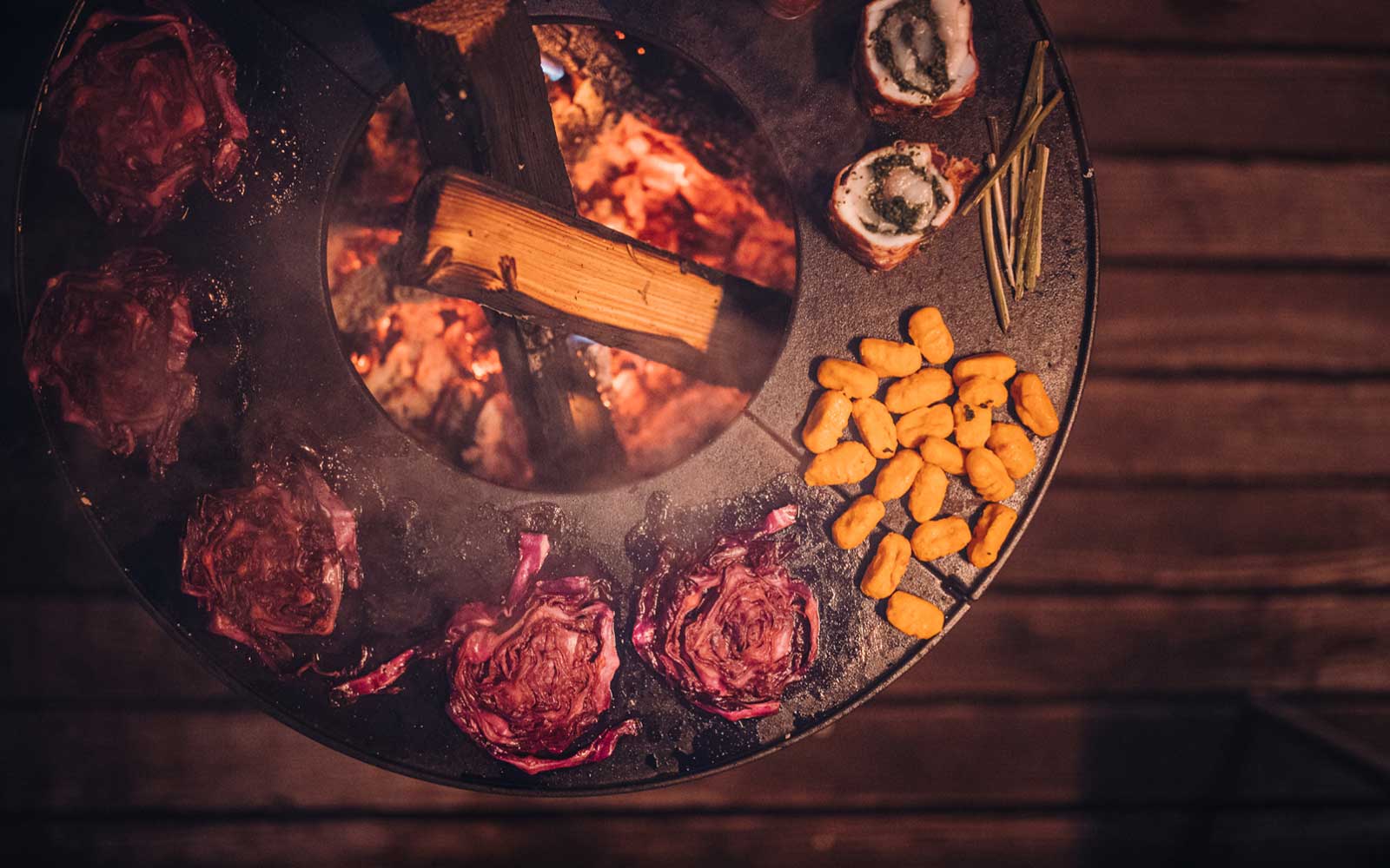 a grill with meat and vegetables on it.