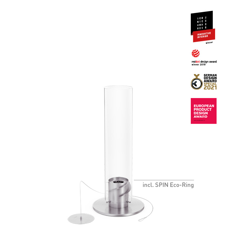 The photo presents a white glass and metal pole with a silver base, with the SPIN 900 Tabletop Fireplace silver.