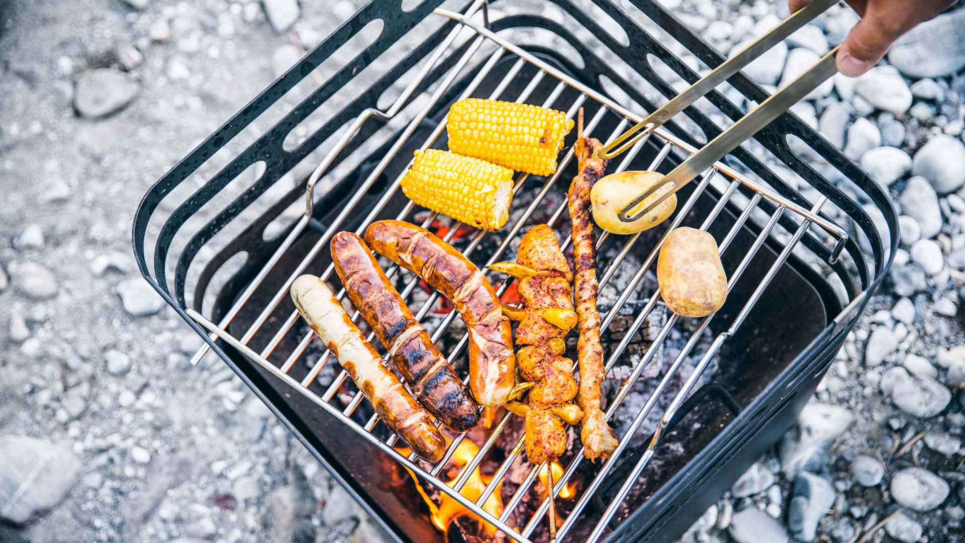 The photo presents a person cooking chicken on a grill, with the CUBE grid.