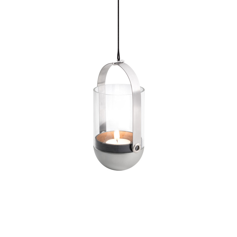 A glass and metal hanging light with a candle inside, with the Gravity Candle Hanging System adding a functional and elegant touch to the scene.