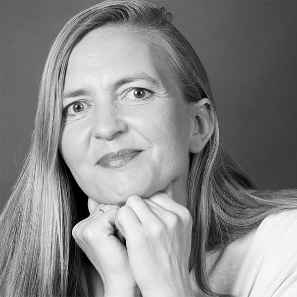 a woman with long hair and a white shirt.