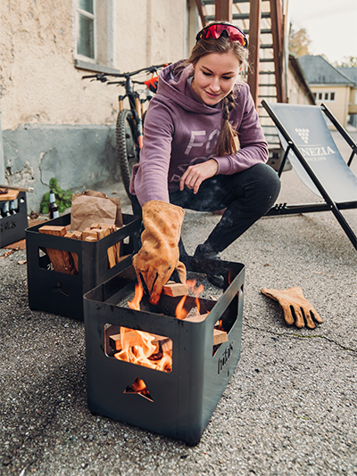 The Firegloves integrates seamlessly into the setting, where a woman sitting on the ground.