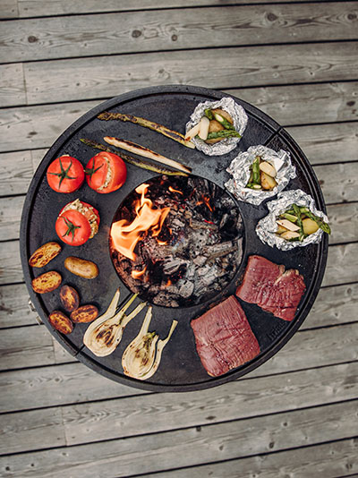 a grill with meat and vegetables on it.