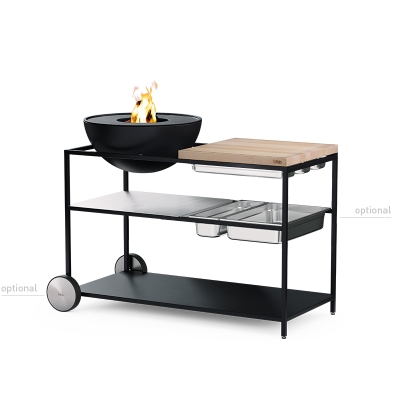 FIRE KITCHEN with BOWL 57 Plancha BBQ Set low Scene showing a black and wood fire pit on a white background, where the 00739 Fire Kitchen Bowl 57 Plancha Grill Set stands out for its practical elegance.