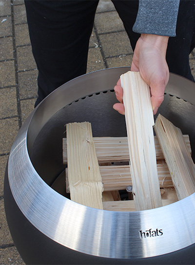 A person is placing a piece of wood into the Moon 45