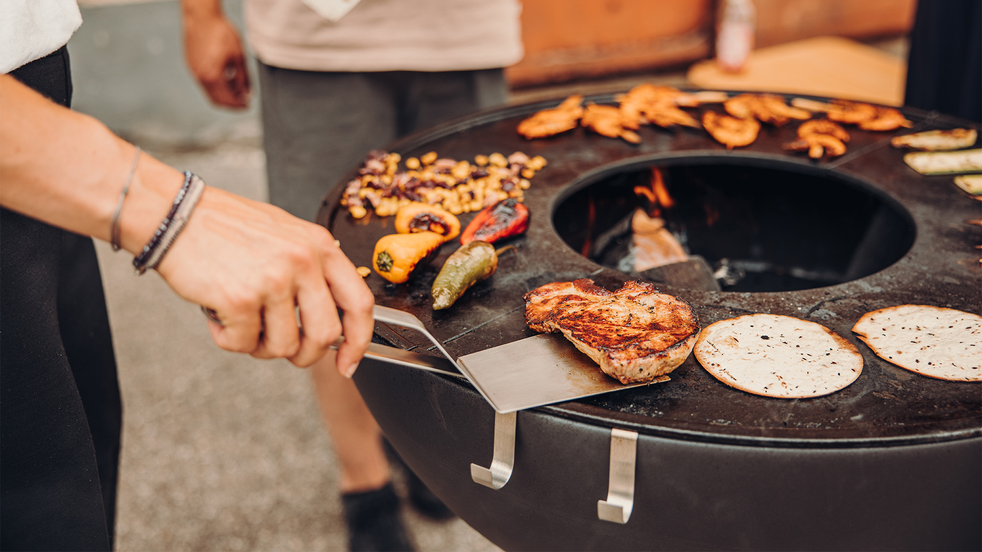The 00473 Spatula is shown as a person is cooking food on a grill, creating a stylish and accessible visual.