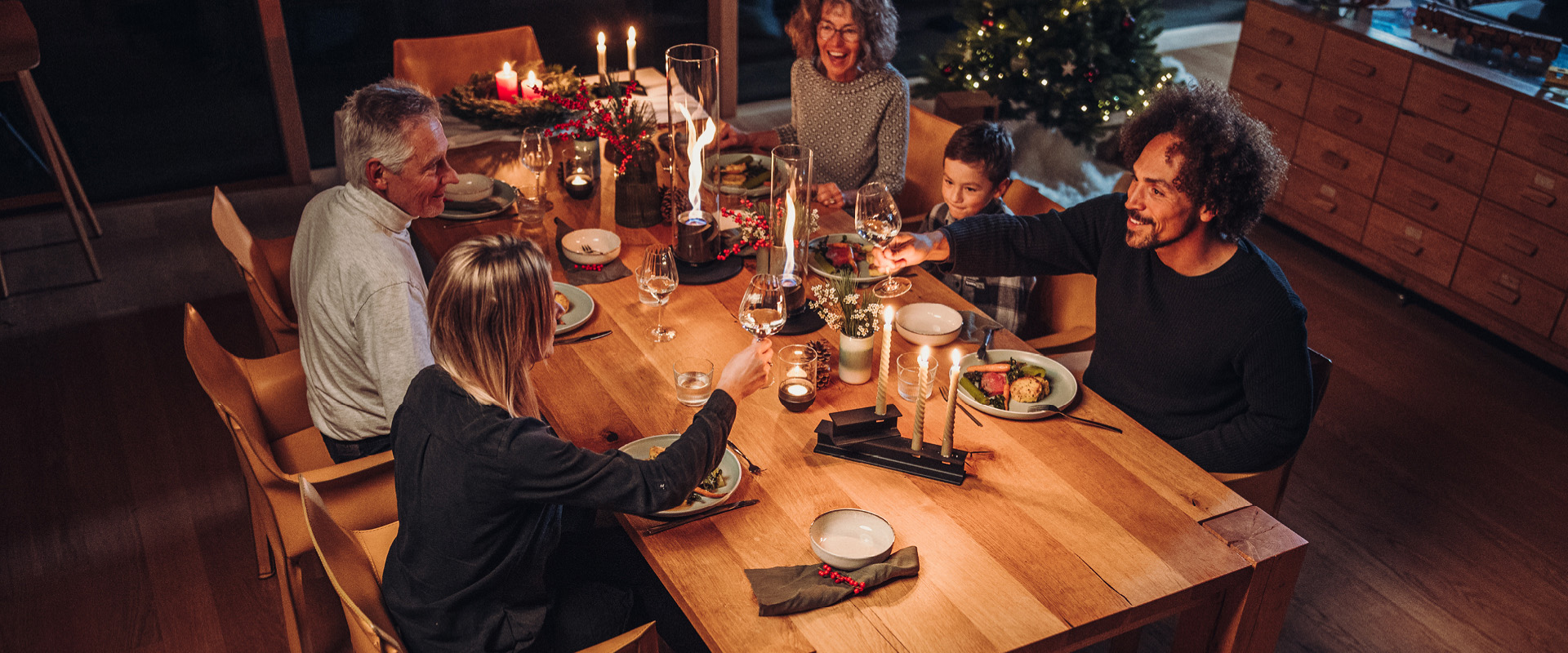 An image showing a group of people sitting around a table, with the BOWL Fire Bowl.