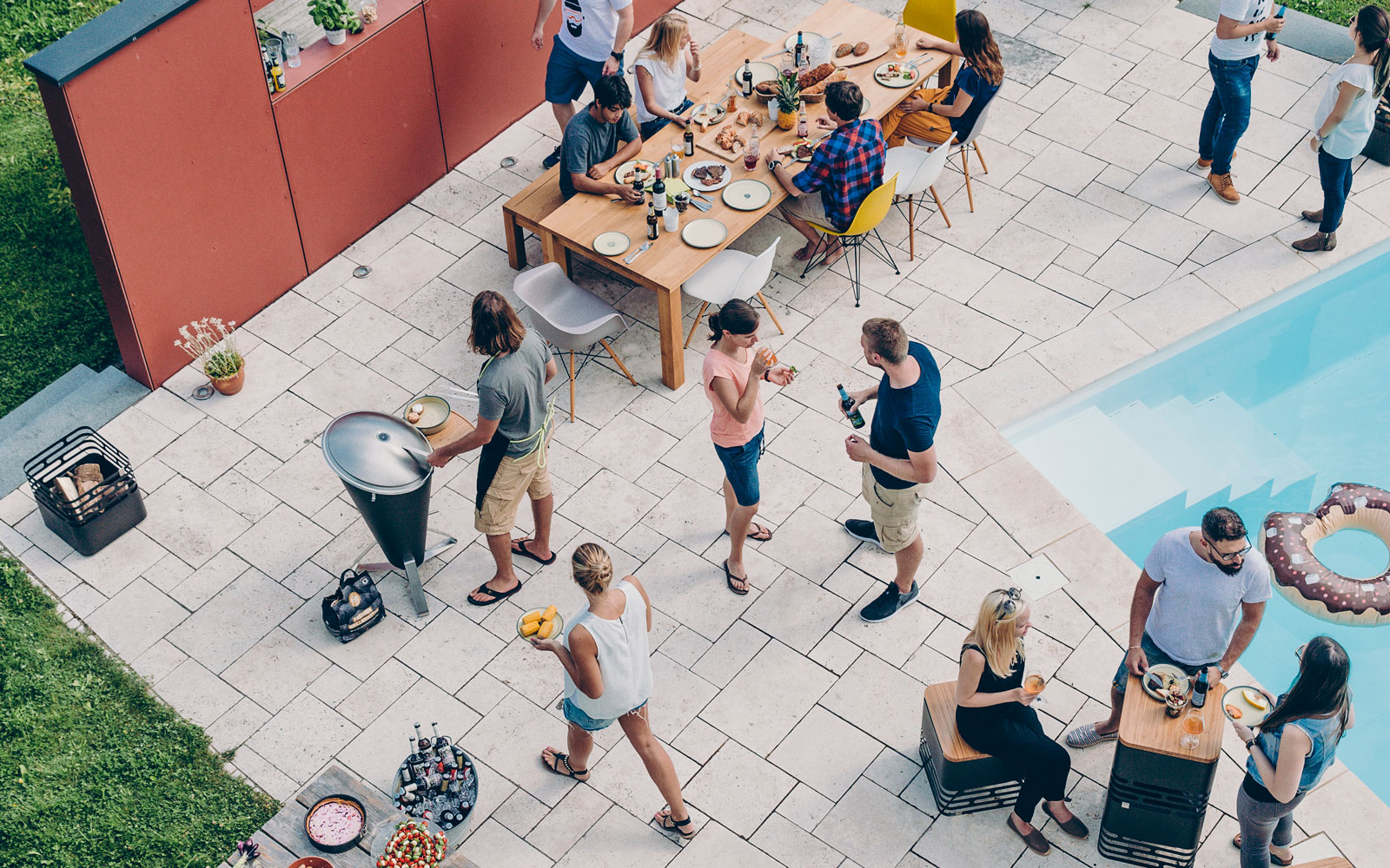 An image showing a group of people are gathered around a pool, with the CONE Board Support.