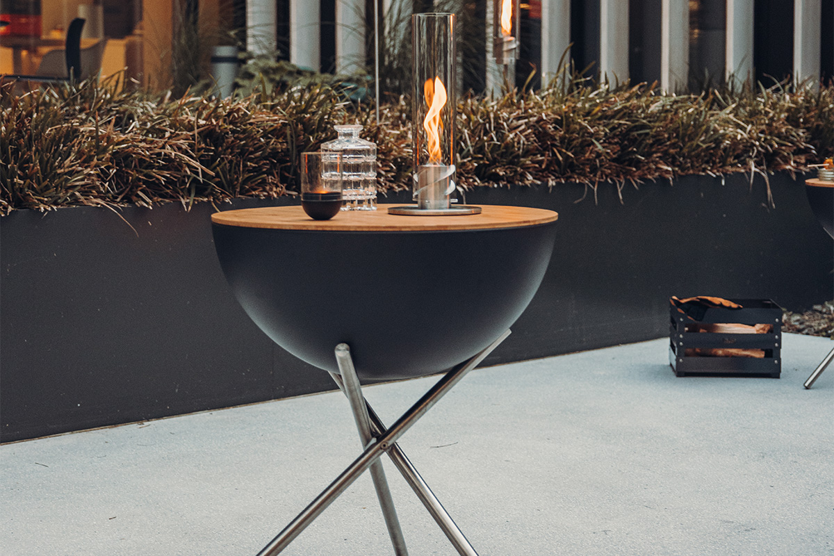 BOWL 70 Board This image shows a fire pit with a fire in it, with the BOWL 70 Board.