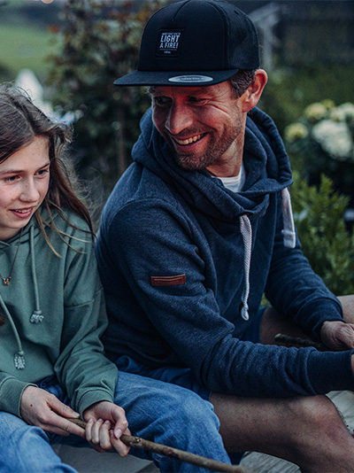 a man and a little girl sitting on a bench