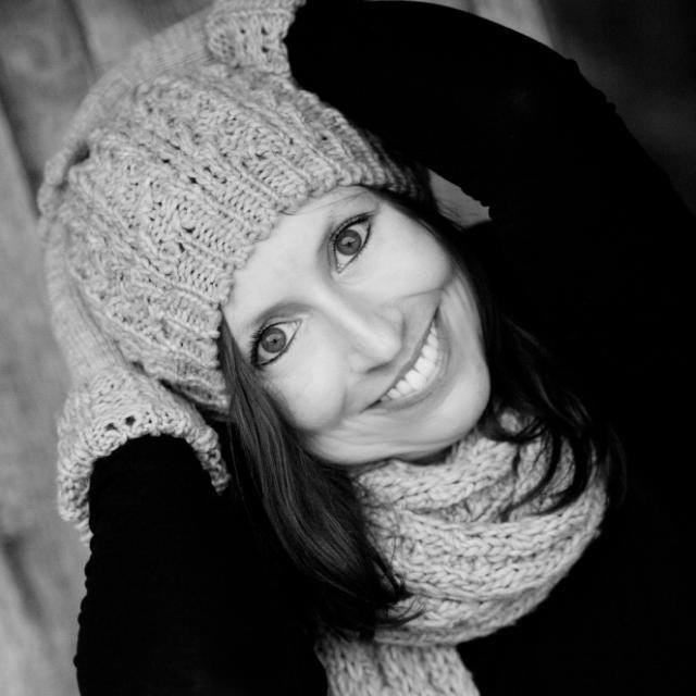 a woman wearing a knit hat and scarf.