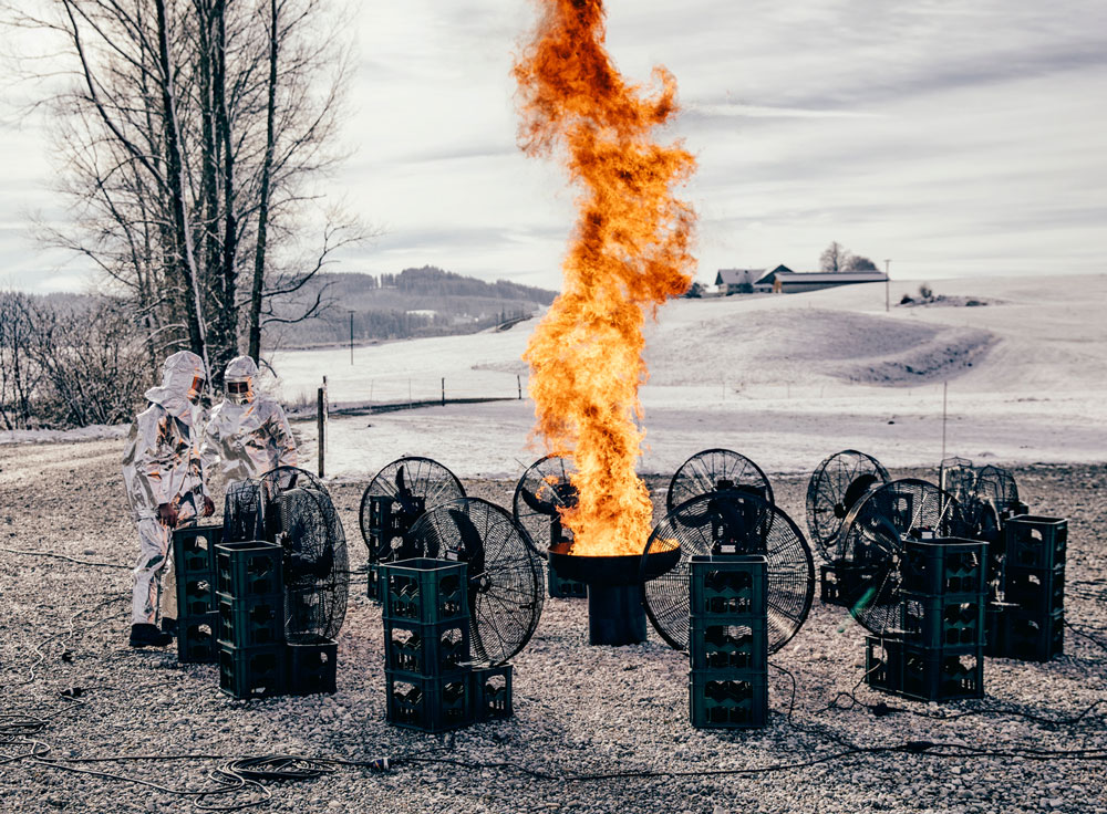 a man in a white shirt and a fire.