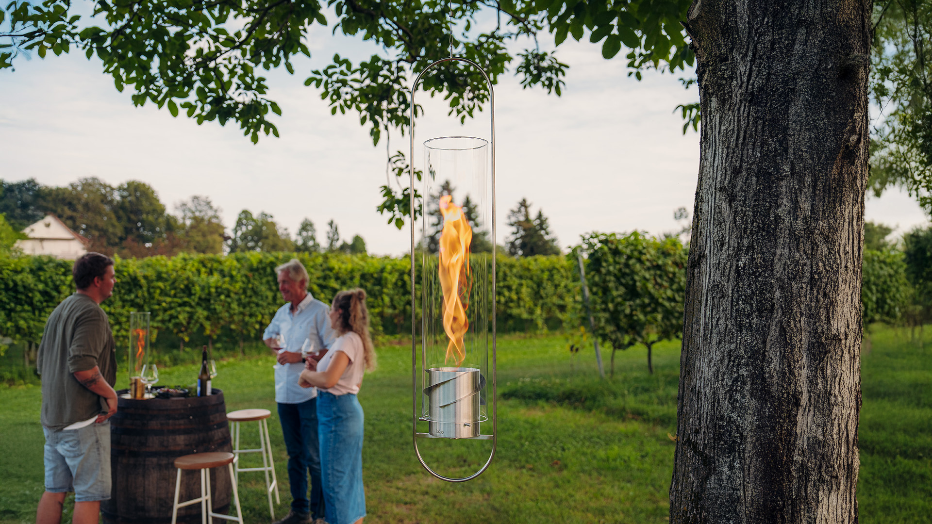 a man and woman standing next to a tree