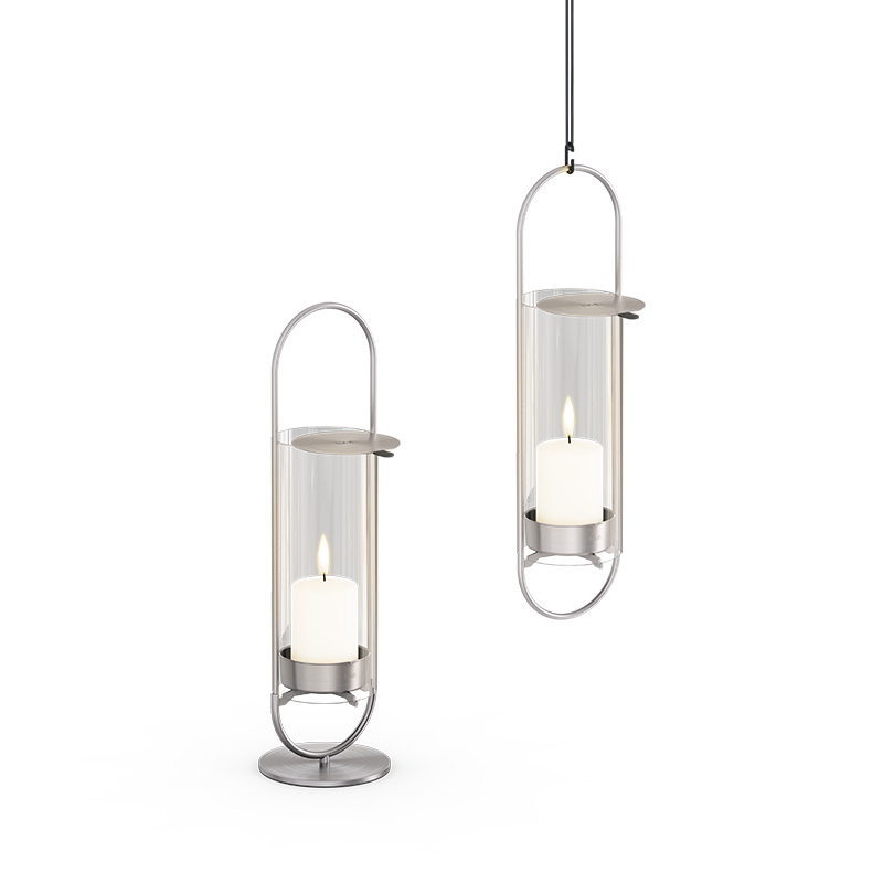 OVAL CANDLE 35 Candleholder silver Illustrated is two silver metal lanterns with white glass, with the OVAL CANDLE 35 Glass Cylinder.