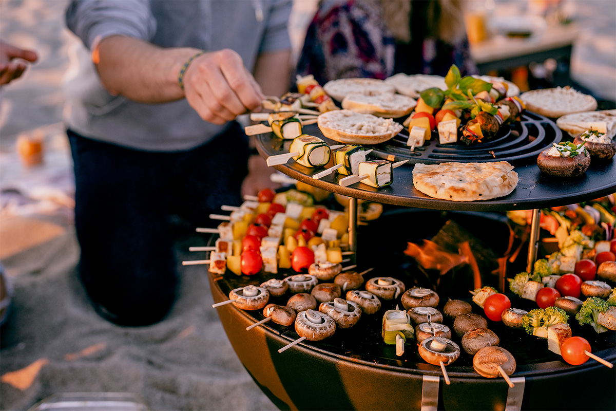 BOWL 57 Warming Ring Illustrated is a table with a variety of food on it, with the BOWL 57 Warming Ring.