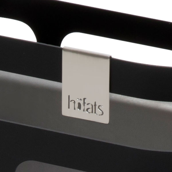 An image showing a black and white bag with a silver tag, with the CUBE Logo Flag.