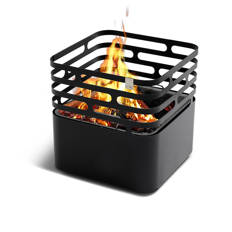 CUBE Fire Basket black A black fire pit with flames inside, with the Cube Firebasket black adding a functional and elegant touch to the scene.