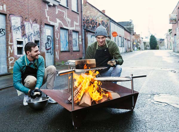 Freestyle BBQ Illustrated is two men sitting around a fire pit, with the BBQ Starter.
